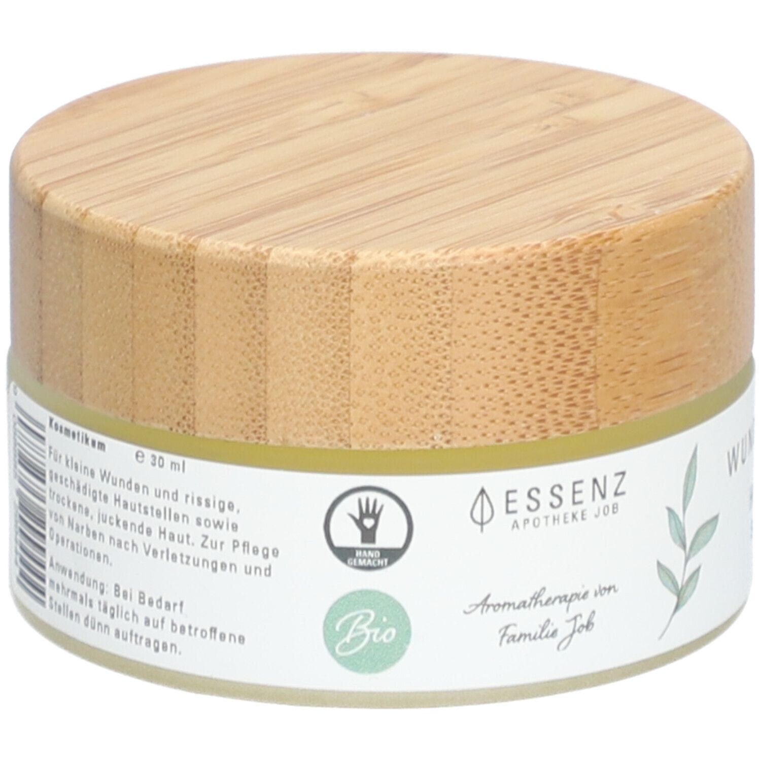 Pot de crème avec couvercle en bois. Inscription : Essenz Apotheke Job, label Bio, Hand Made. Texte pour petites plaies et peau gercée.