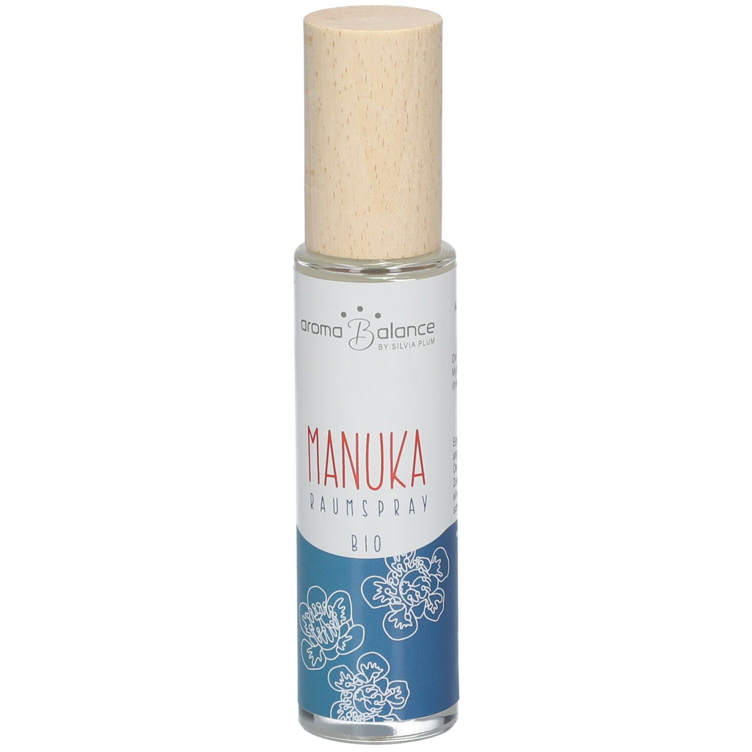 Aroma Balance Manuka Raumspray Bio. Zylindrische Glasflasche mit Holzverschluss. Etikett mit Produktnamen und floralem Muster.