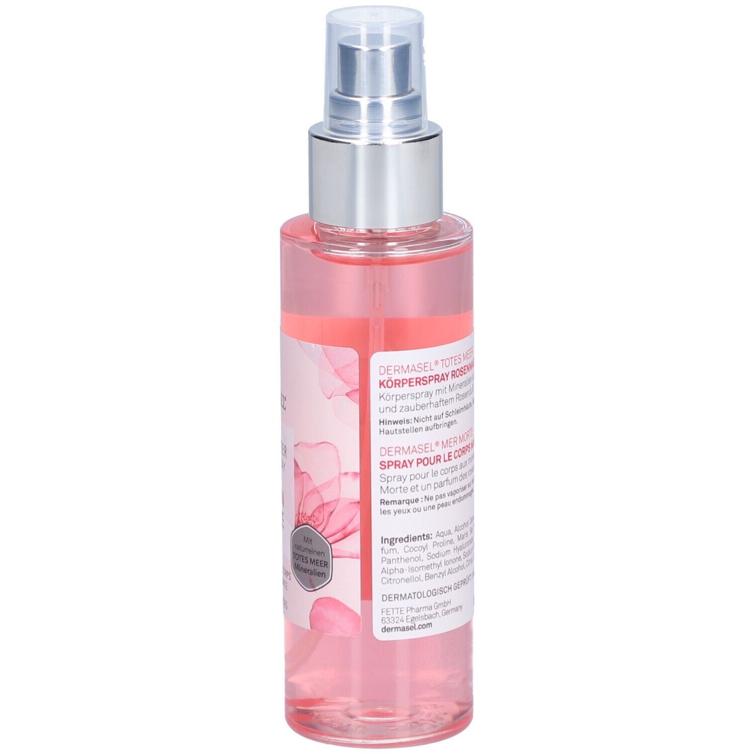Flacon de spray pour le corps. Liquide rose. Inscription: DERMASEL, TOTES MEER KÖPERSPRAY ROSEN MAGIE. Dos avec texte et ingrédients.