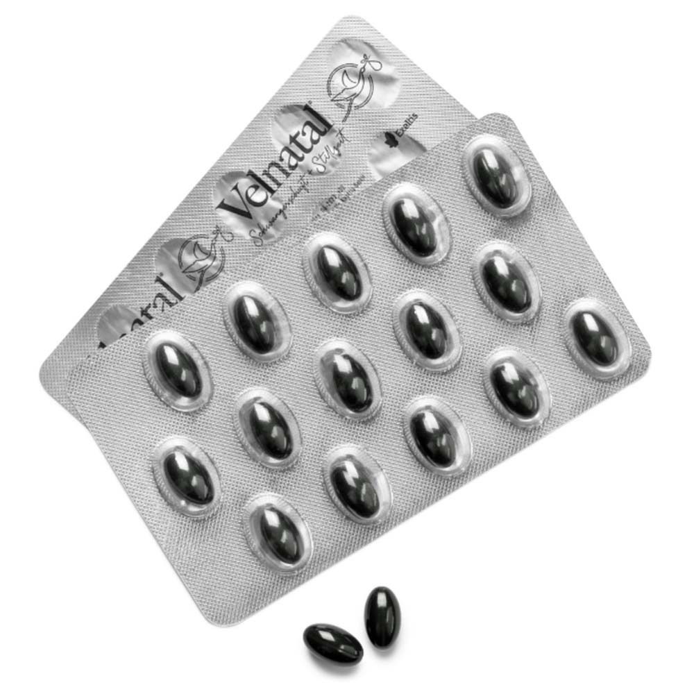 Zwei Blisterpackungen mit schwarzen Kapseln. Velnatal-Logo auf den Blistern. Einzelne Kapsel daneben.