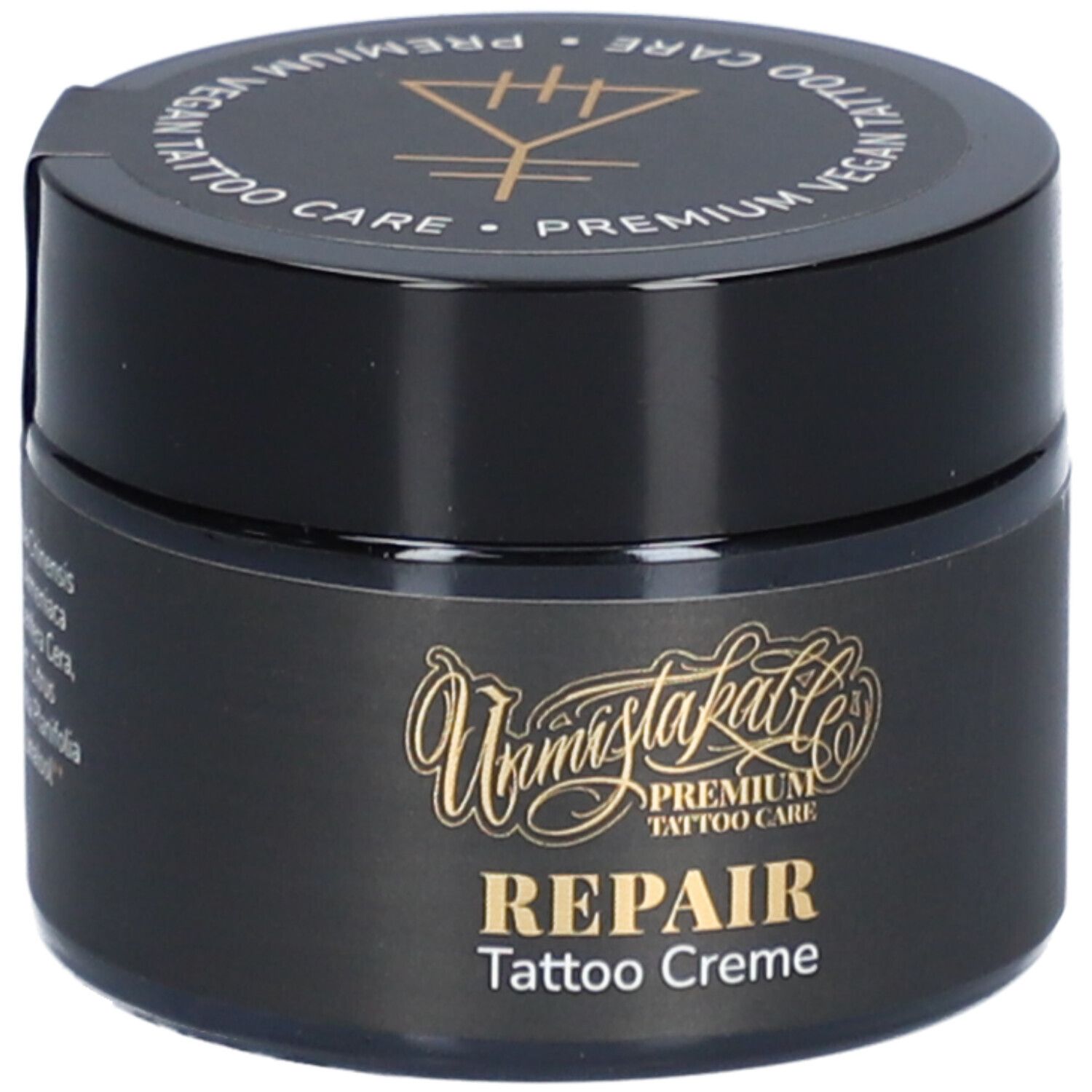 Pot noir avec texte doré. Inscription: REPAIR Tattoo Creme. Couvercle avec texte: Premium Vegan Tattoo Care.