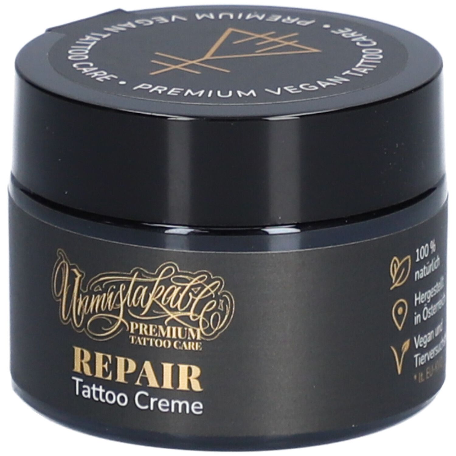 Pot noir avec texte doré. Inscription: REPAIR Tattoo Creme. Couvercle avec texte: Premium Vegan Tattoo Care. Avec logo.