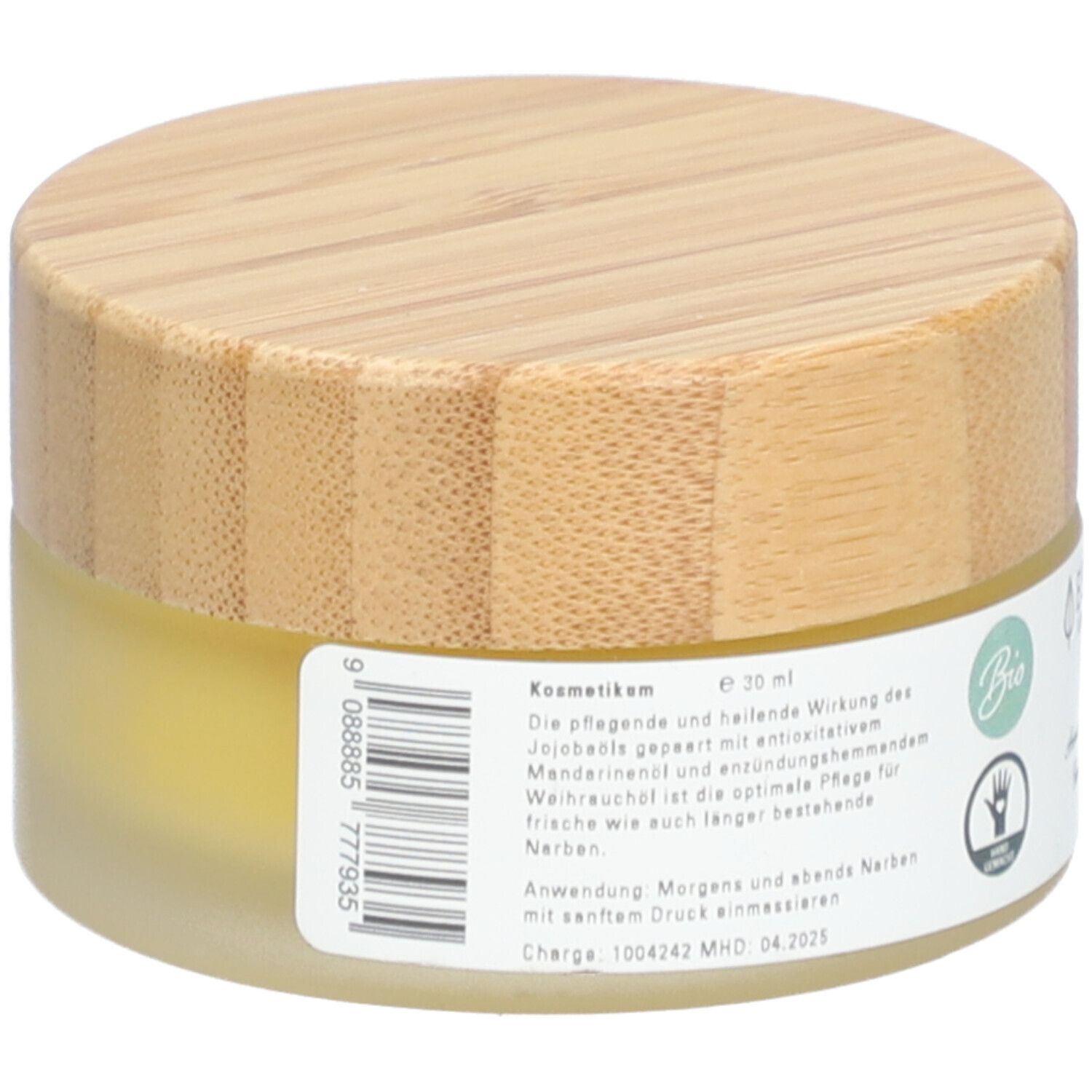 Pot rond avec couvercle en bois. Étiquette avec texte et ingrédients. "Essenz Narbensalbe".