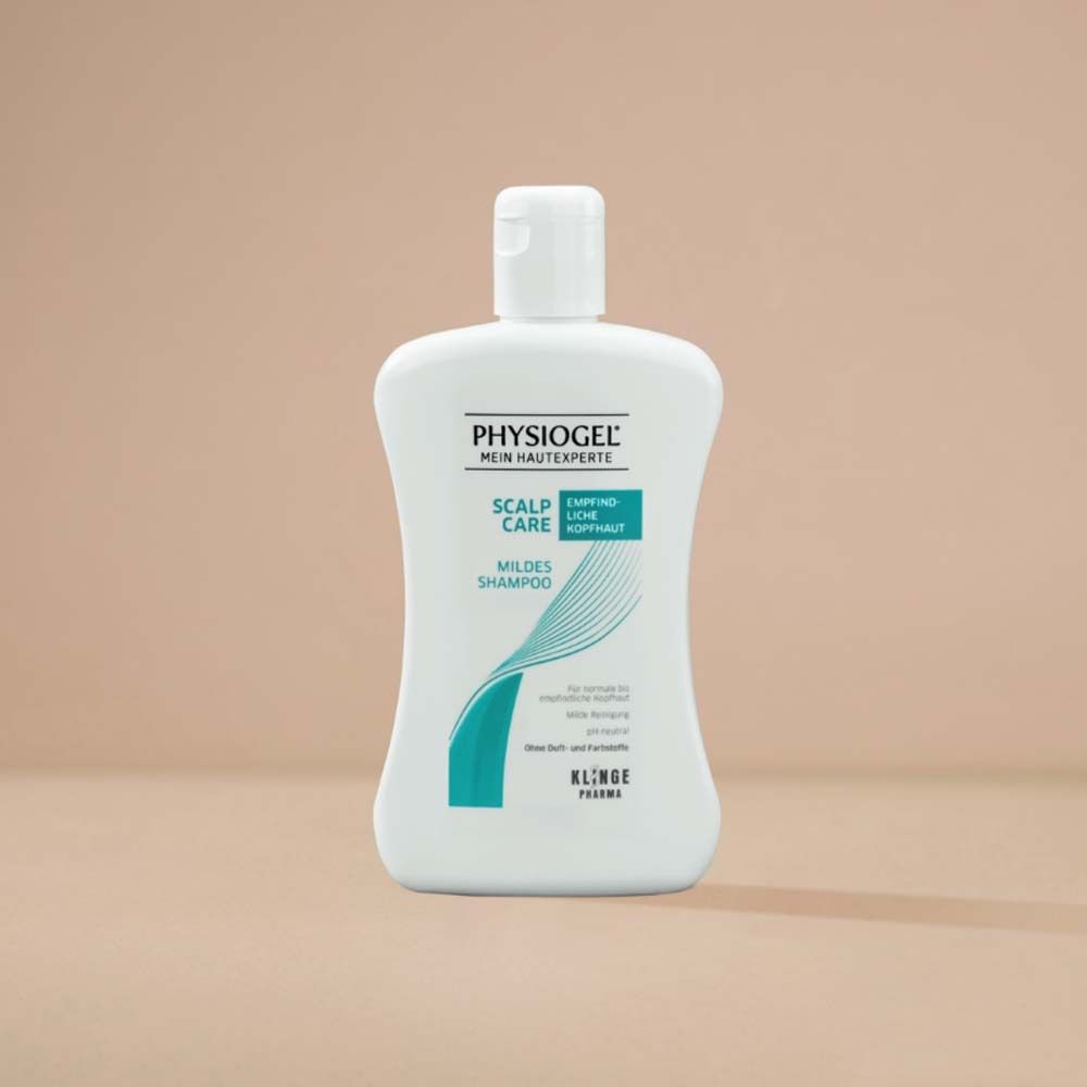 Weiße Flasche PHYSIOGEL Scalp Care Mildes Shampoo. Aufschrift: Hypoallergen, für empfindliche Kopfhaut. Hintergrund: hellbraun.