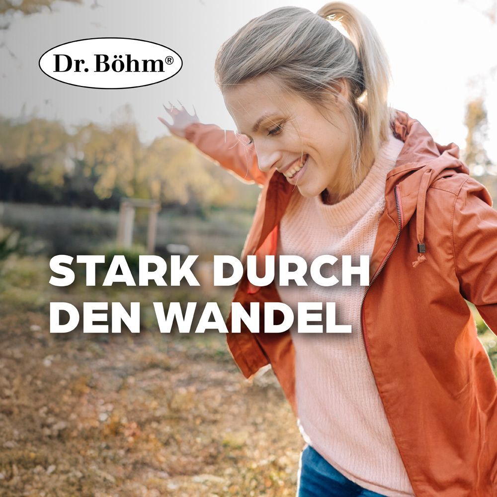 Femme souriante à l'extérieur. Texte : Fort à travers le changement. Logo : Dr. Böhm®.