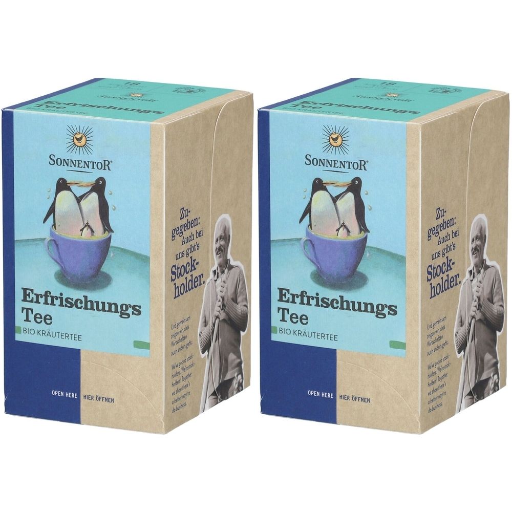 Zwei Kartons SonnentoR Erfrischungs Tee. Aufdruck: Pinguine in Tasse, Logo, Produktname. Verpackung aus Pappe mit blauen und hellblauen Akzenten.