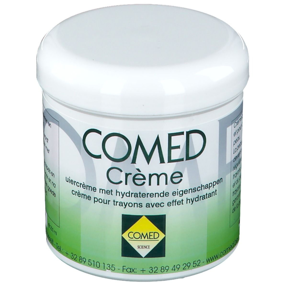 Weißer Tiegel mit grünem Etikett. Aufschrift: COMED Crème. Text in Deutsch, Französisch und Niederländisch. Gelbes Logo.