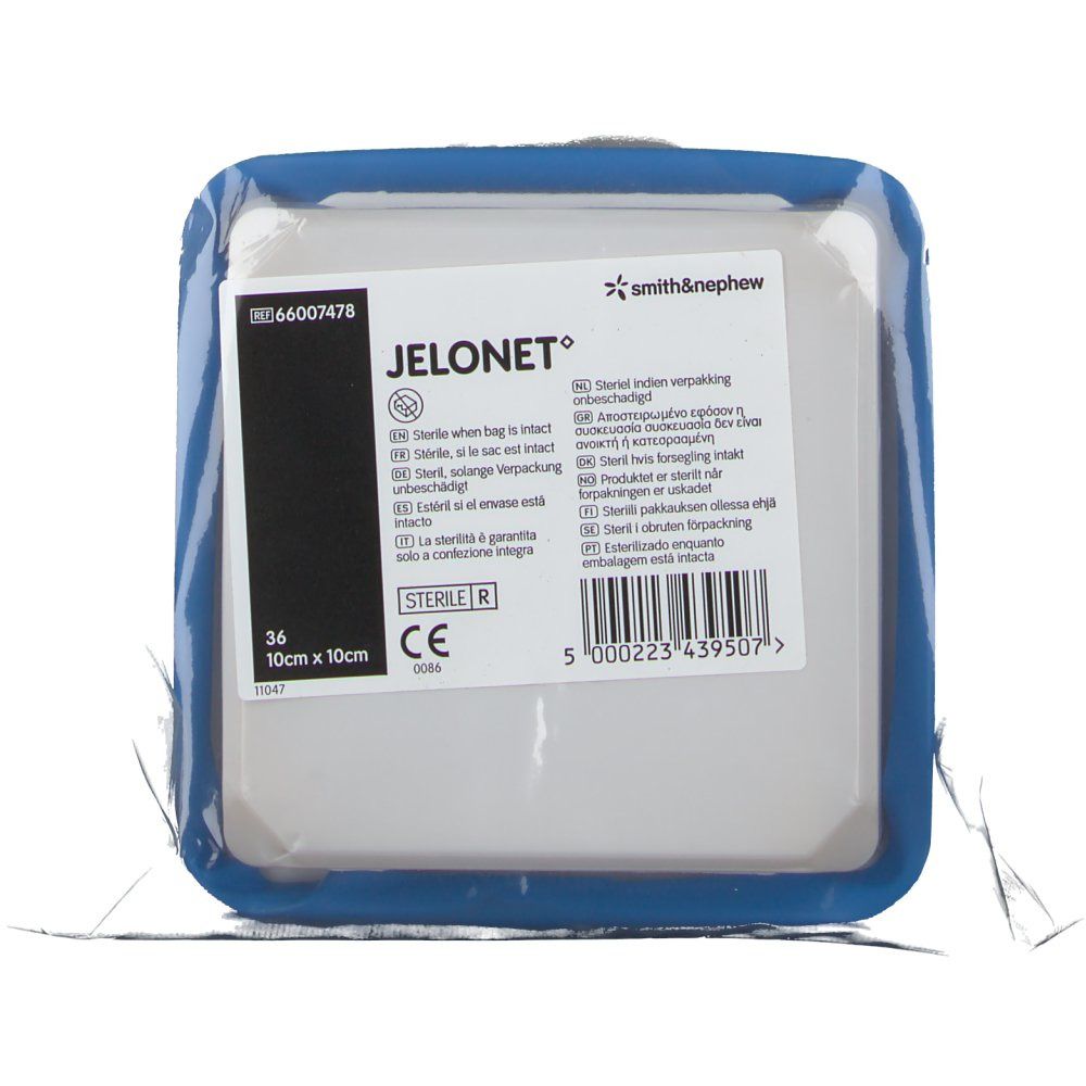 Verpackte JELONET Salbenkompresse. Quadratische Form, blaue Umrandung. Text: 10cm x 10cm, Smith & Nephew Logo.