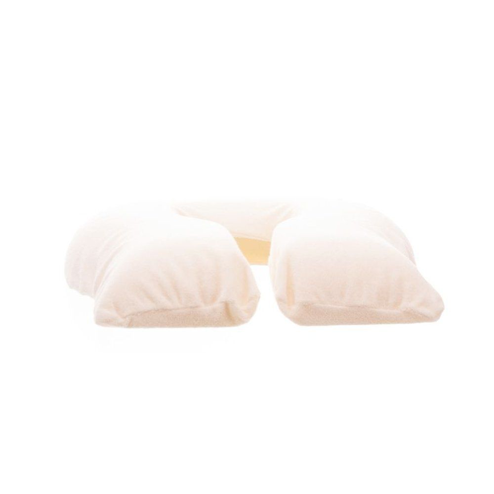 Coussin beige en forme de fer à cheval, vue latérale. Matière douce, forme claire.