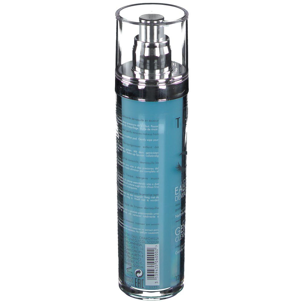 Flacon cylindrique avec pompe. Liquide bleu turquoise. Inscriptions et texte sur le flacon. Bouchon argenté.