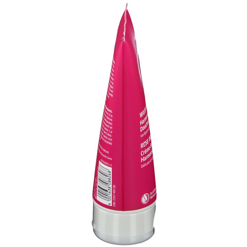 Seitenansicht der Tube. Rosa Tube mit weißem Verschluss. Text und Barcode sichtbar. Produktname und Logo teilweise erkennbar.