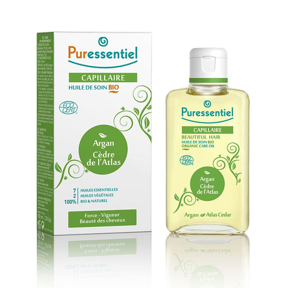 Pflegeöl-Flasche und Verpackung. Aufschrift: Capillaire, Huile de soin bio, Argan Cèdre de l'Atlas. Mit 7 ätherischen Ölen.