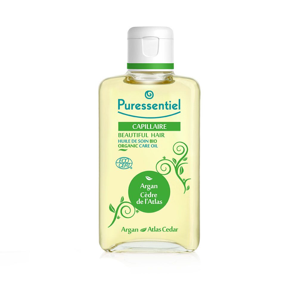 Flasche Pflegeöl. Aufschrift: Capillaire, Huile de soin bio, Argan Cèdre de l'Atlas. Mit 7 ätherischen Ölen.