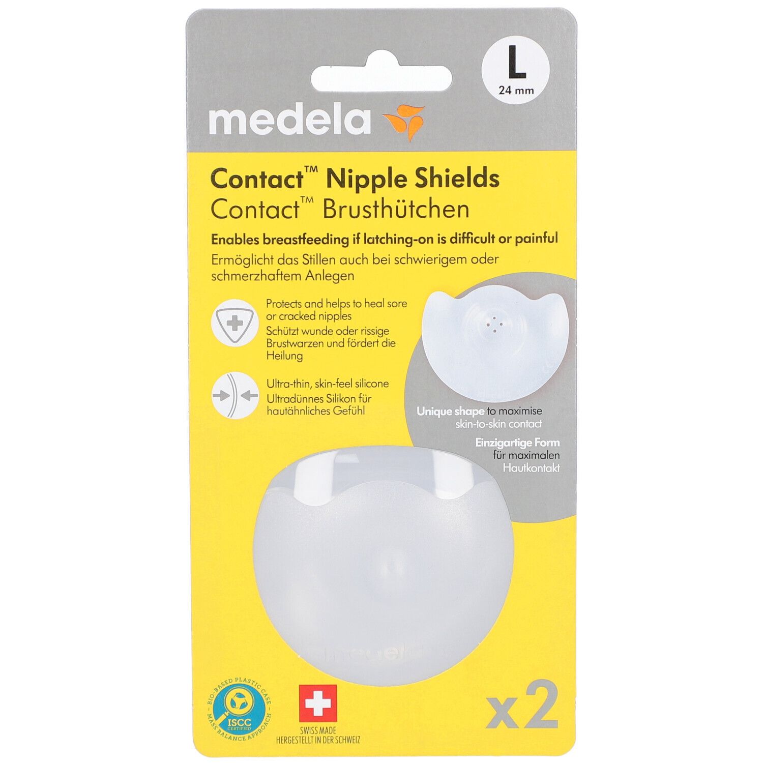 Verpackung mit zwei Brusthütchen. Marke: Medela. Größe L, 24 mm. Transparente Silikonhütchen in gelber Verpackung.