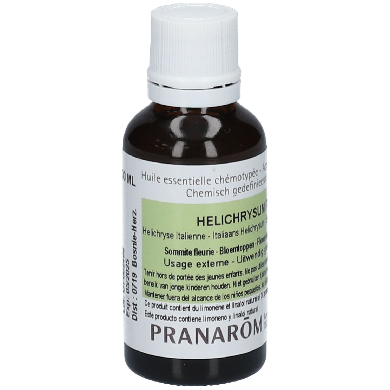 Flacon en verre brun avec bouchon blanc. Étiquette avec texte: Helichrysum italicum, PRANAROM.