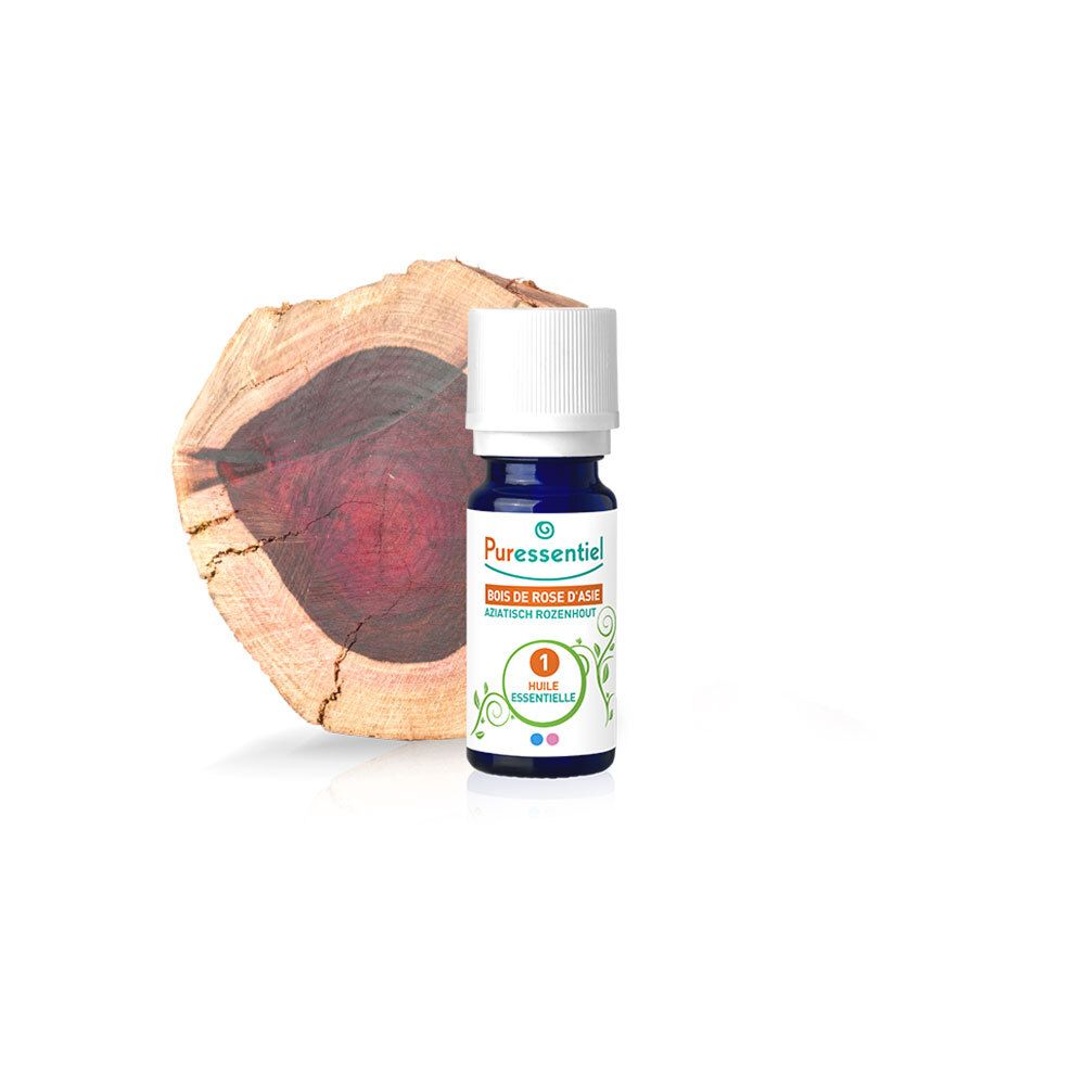 Fläschchen mit ätherischem Öl neben einem Holzstück. Aufschrift: Bois de Rose d'Asie, 1 Huile Essentielle.