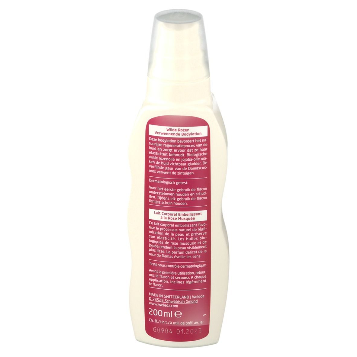 Weleda Bodylotion-Flasche. Rückansicht. Weißes Gefäß mit rosa Etikett. Text und Inhaltsangaben. Transparenter Sprühkopf.