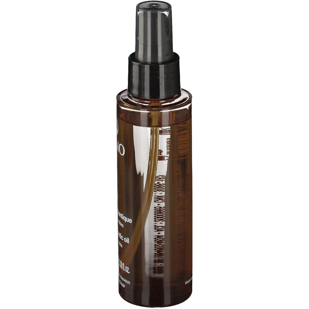 Braune Sprühflasche mit schwarzem Sprühkopf. Etikett mit Produktinformationen. Transparente Flüssigkeit sichtbar.