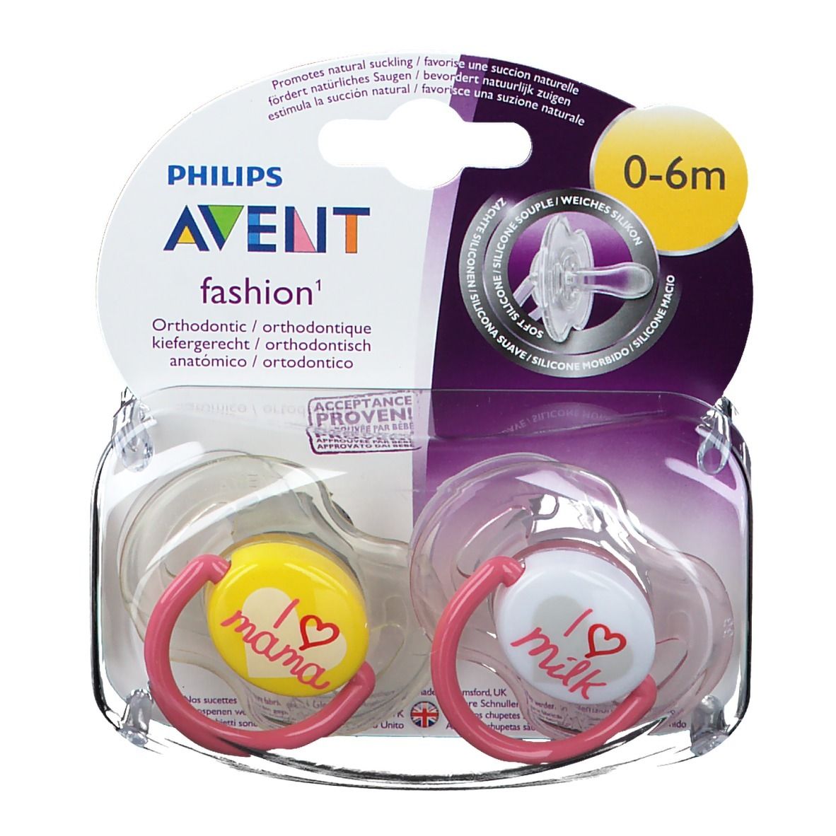 Zwei Schnuller in Verpackung. Gelber Schnuller mit "I love mama", weißer mit "I love milk". Pinke Ringe. 0-6m.