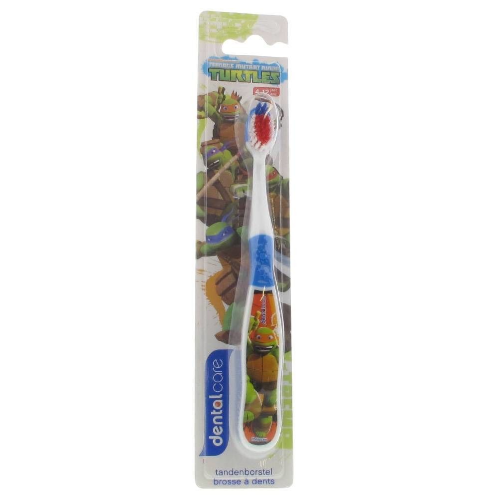 Brosse à dents pour enfants, emballée. Tête blanche avec poils rouges et bleus. Manche bleu avec motif de tortue. Emballage avec logo.