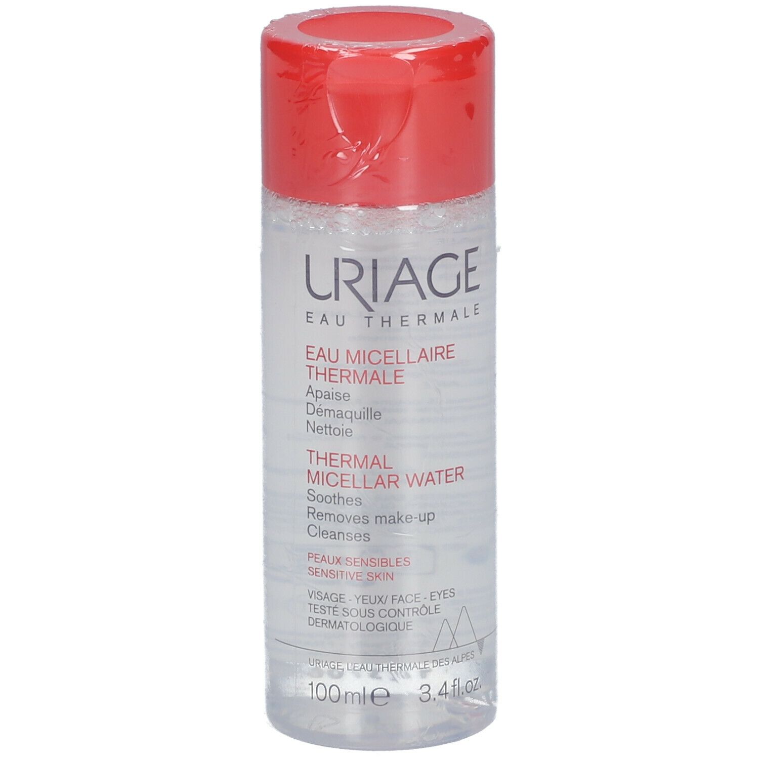 Uriage Eau Micellaire Thermale. Flacon transparent, bouchon rouge. Inscription et texte sur l'étiquette.