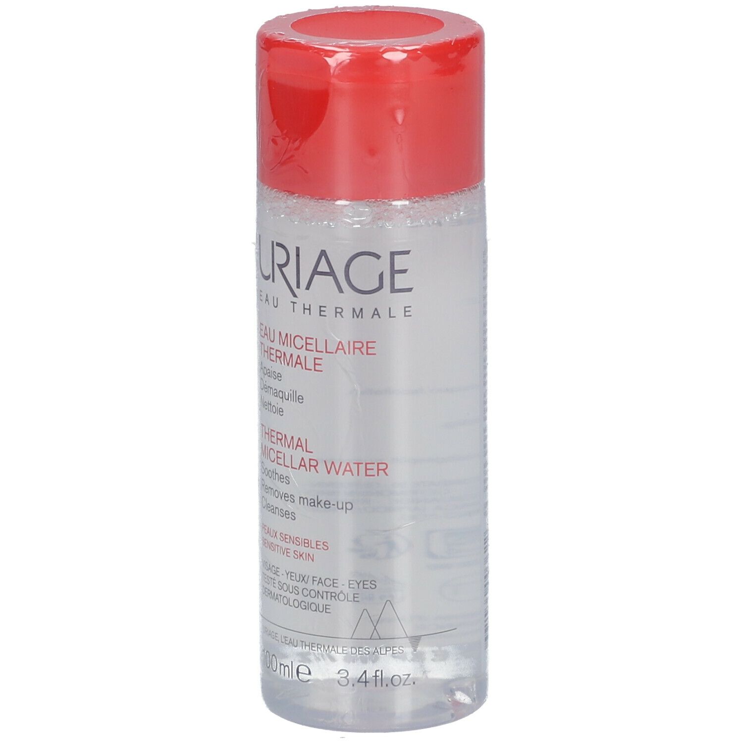 Uriage Eau Micellaire Thermale. Flacon transparent, bouchon rouge. Inscription et texte sur l'étiquette.