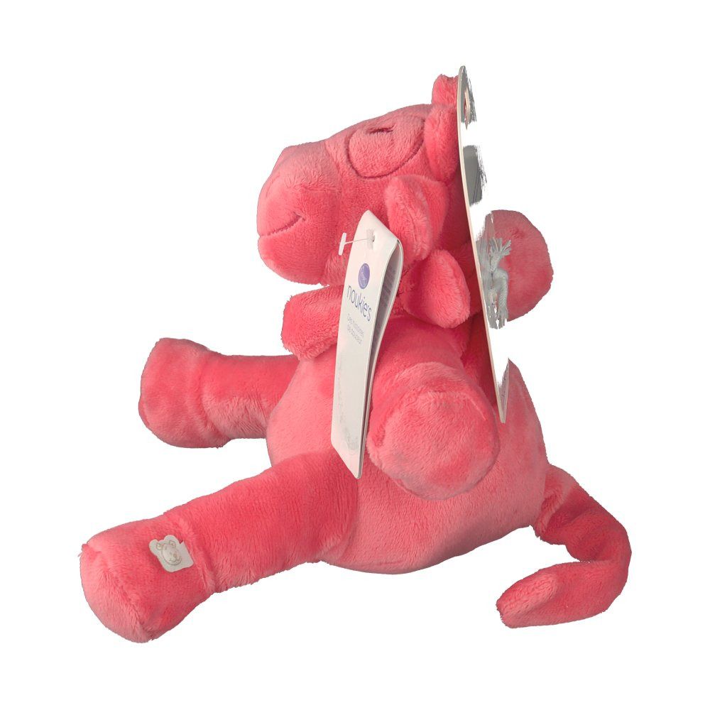 Peluche rose en forme de vache. Vue latérale. Étiquette avec 'noukies'. Matière douce. Logo cousu.