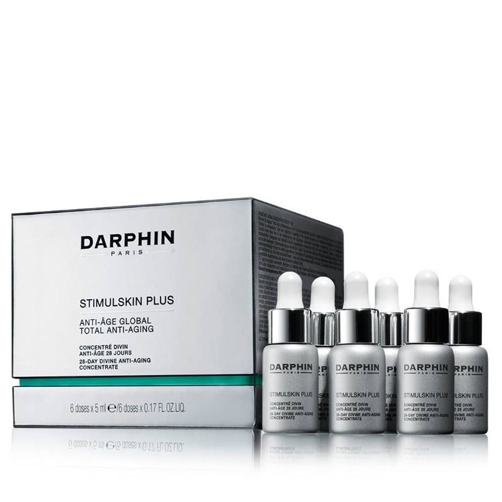 Sechs Fläschchen mit silbernen Kappen und Pipetten neben einer weißen Schachtel mit Produktinformationen.