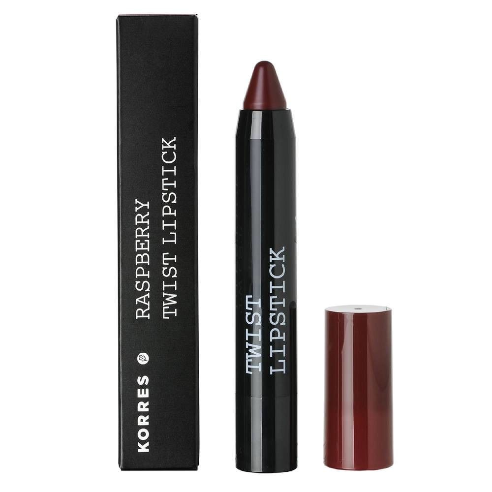 Korres Himbeere Twist Lippenstift. Dunkelroter Lippenstiftstift mit schwarzer Hülle und separater Kappe. Schwarze Verpackung mit Text.