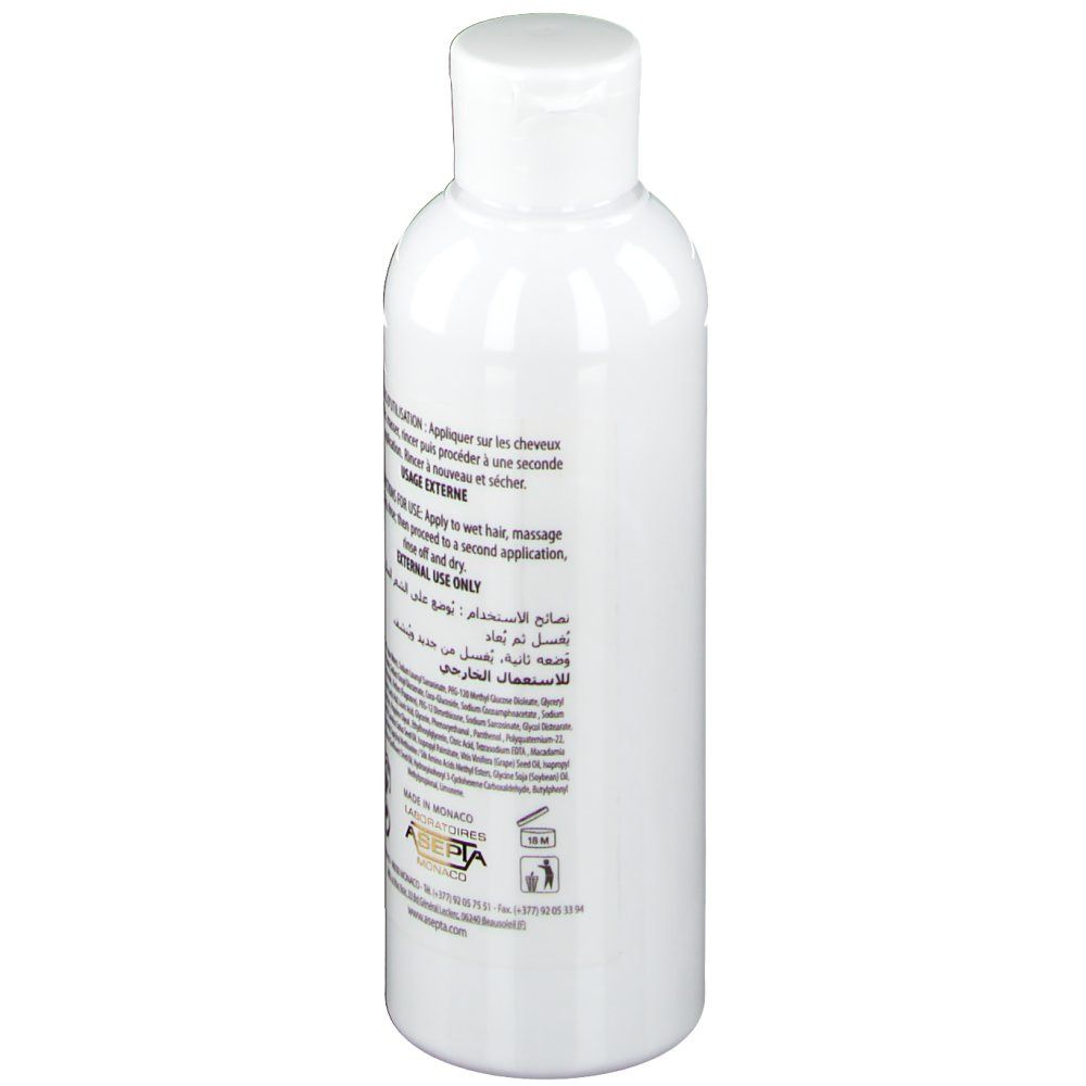 Ecrinal ANP 2+ Shampoo Frau. Rückseite der weißen Flasche. Text und Informationen zur Anwendung.