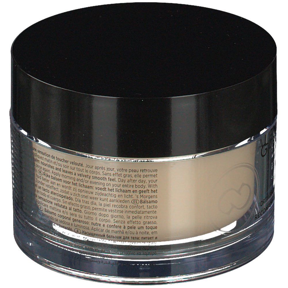 Pot vu de dos. Couvercle noir, contenant transparent. Texte en plusieurs langues.