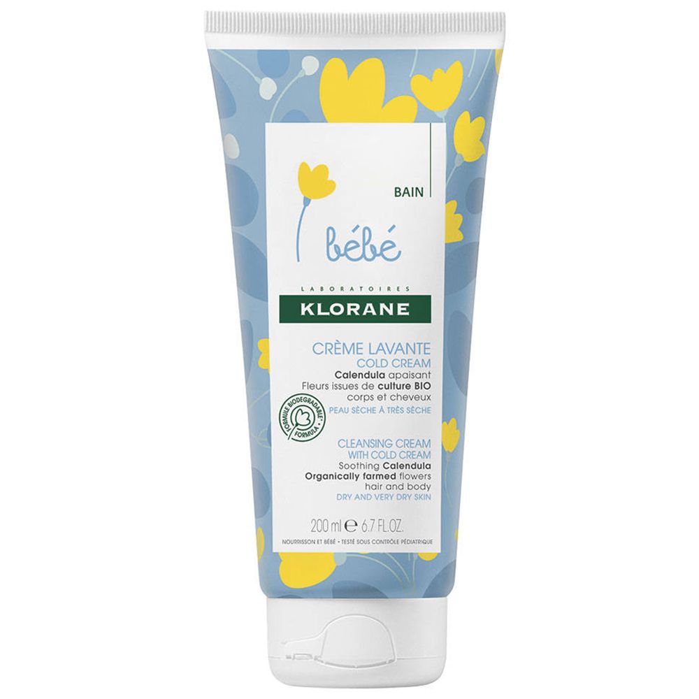 Tube de crème lavante bébé Klorane. Motif floral bleu et jaune. Inscriptions du produit et ingrédients visibles.
