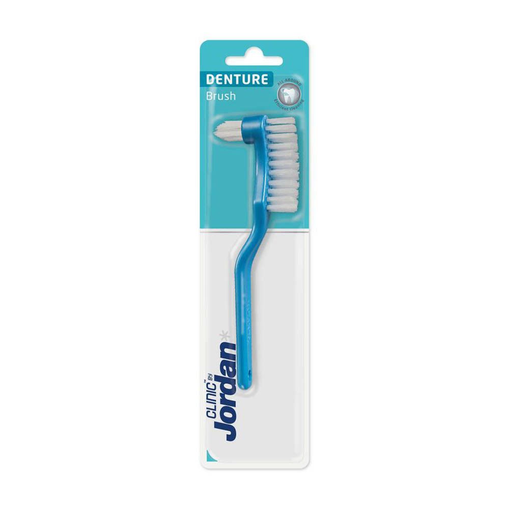 Zahnbürste für Prothesen in Blisterverpackung. Blaue Bürste mit weißem Borstenkopf. Markenname Jordan Clinic.