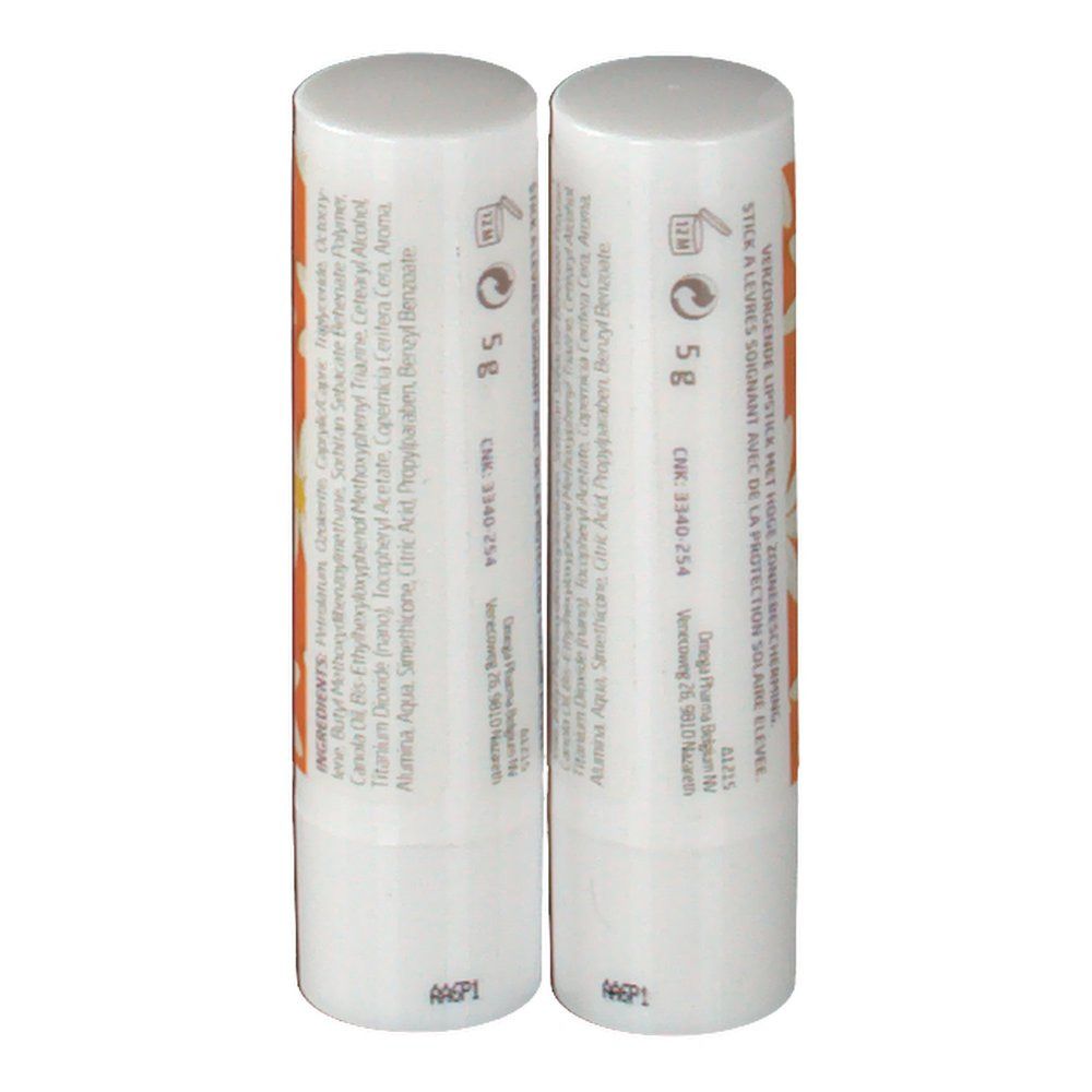 Deux rouges à lèvres avec capuchon blanc. Dos avec ingrédients et texte. Motif marguerite sur fond orange.