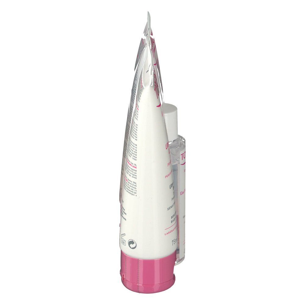 Seitenansicht einer Kosmetiktube. Weiße Tube mit rosa Akzenten. Produkt steht aufrecht.