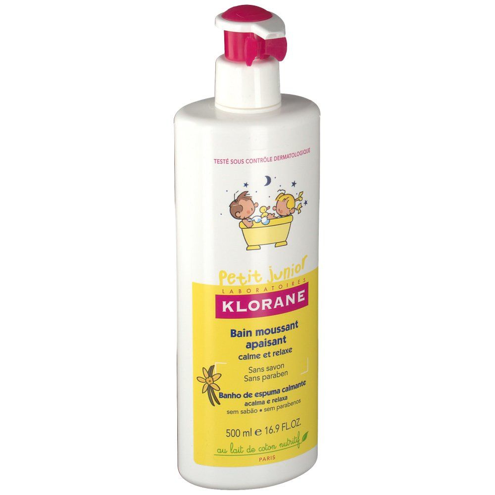 Weiße Flasche mit rosa Pumpkopf. Gelbes Etikett mit Text und Illustrationen. Aufschrift: Klorane Petit Junior, beruhigendes Schaumbad.