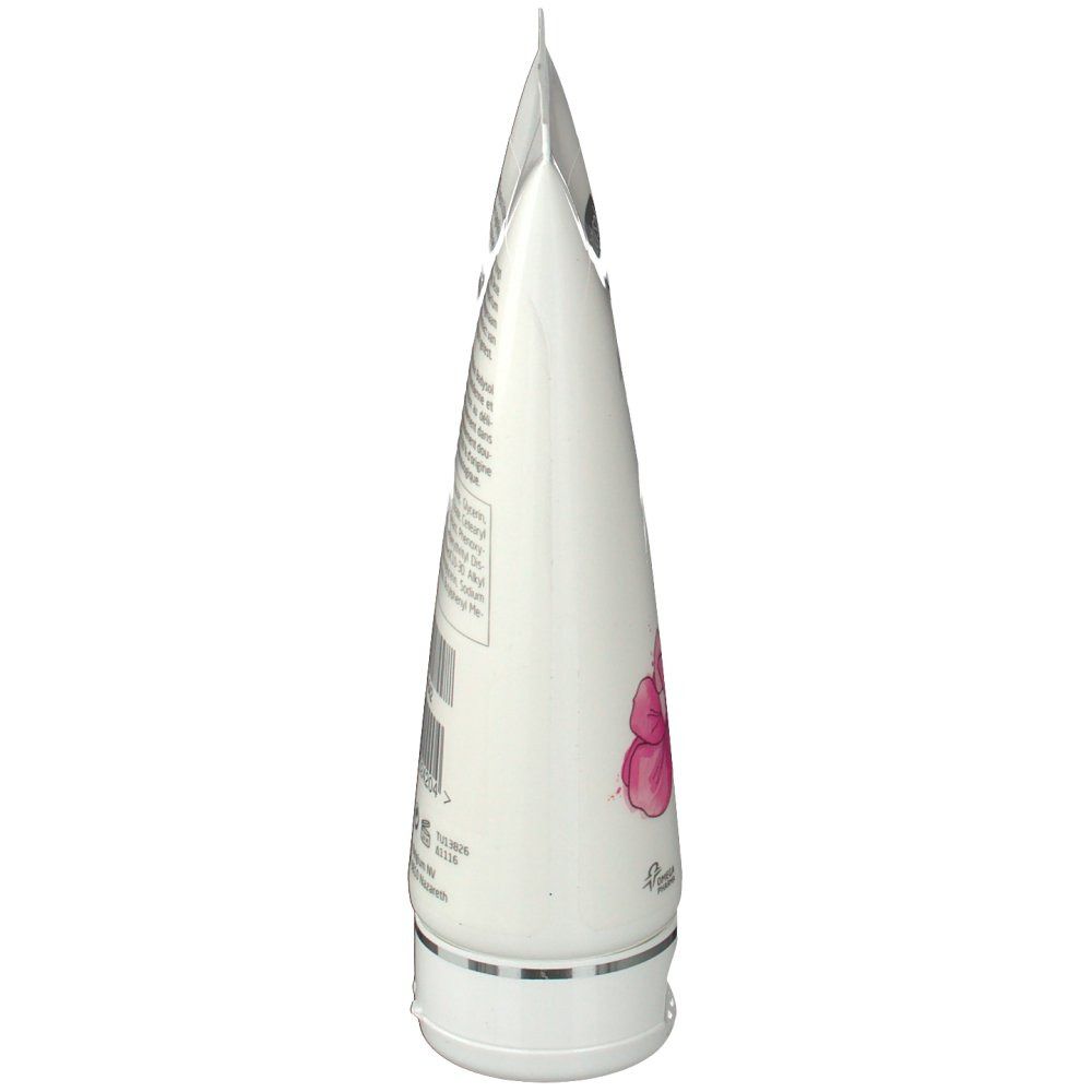 Seitenansicht einer weißen Tube. Enthält Text und eine Orchideen-Illustration.