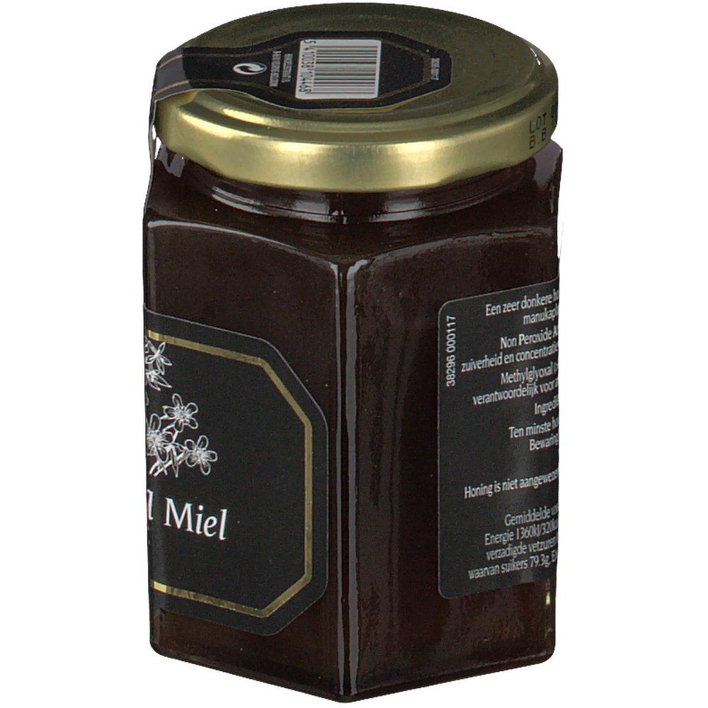 Pot de miel hexagonal avec étiquette noire et couvercle doré. Étiquette avec motif floral et texte.