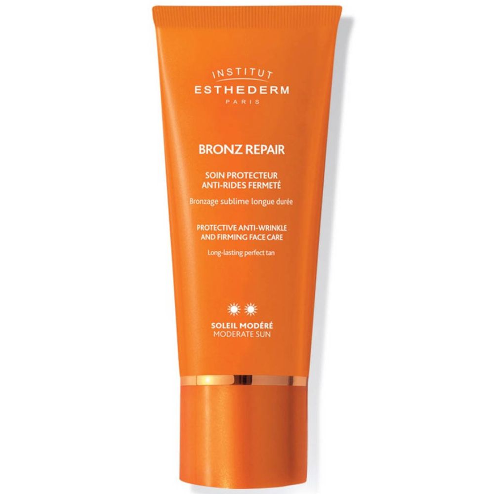 Orange Tube mit Aufschrift INSTITUT ESTHEDERM, BRONZ REPAIR, und weiteren Texten. Sonnenschutzmittel.