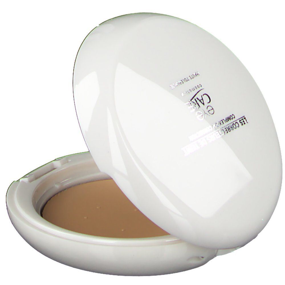 Maquillage compact ovale blanc partiellement ouvert. Produit et texte visibles sur le couvercle.
