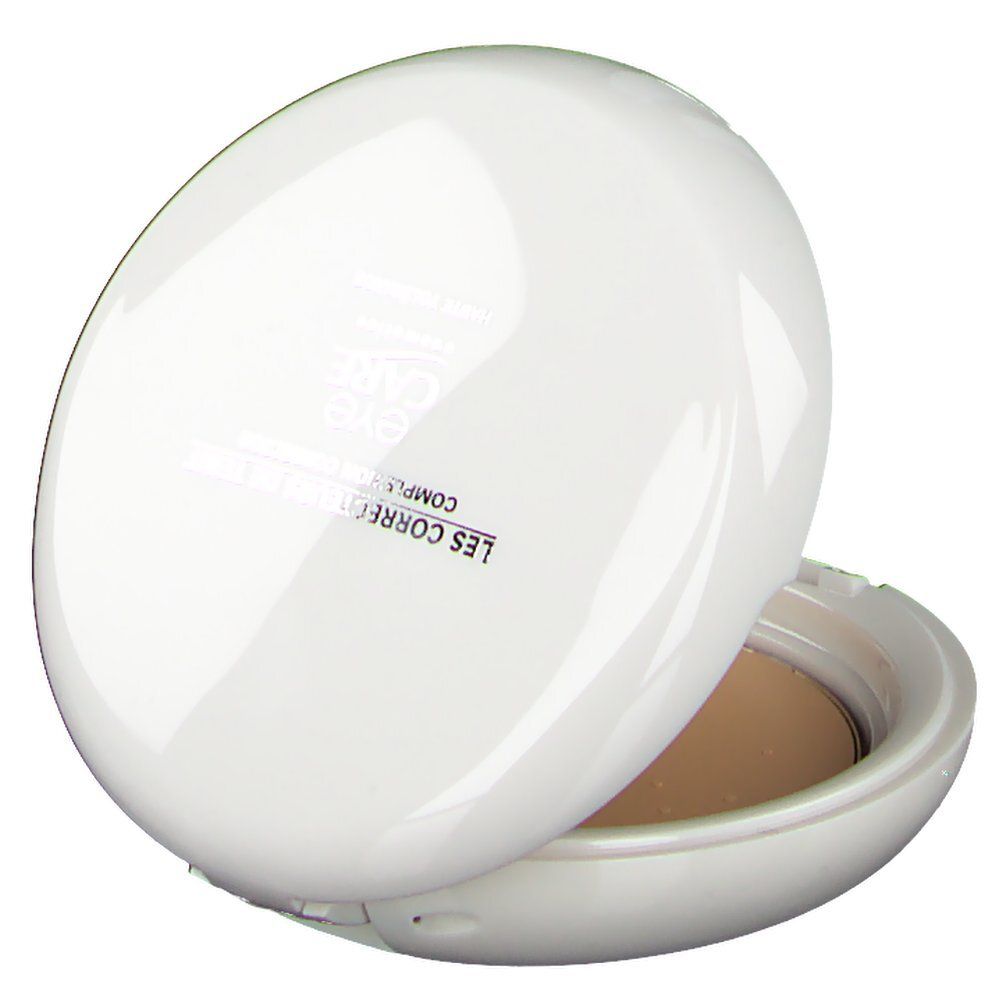Maquillage compact ovale blanc partiellement ouvert. Texte visible sur le couvercle.