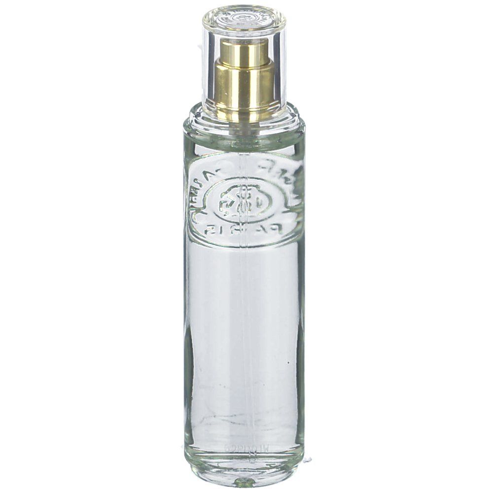 Zylindrische Glasflasche mit Sprühkopf. Klar, mit goldfarbenem Zerstäuber und durchsichtiger Kappe. Geprägtes Logo auf der Vorderseite.