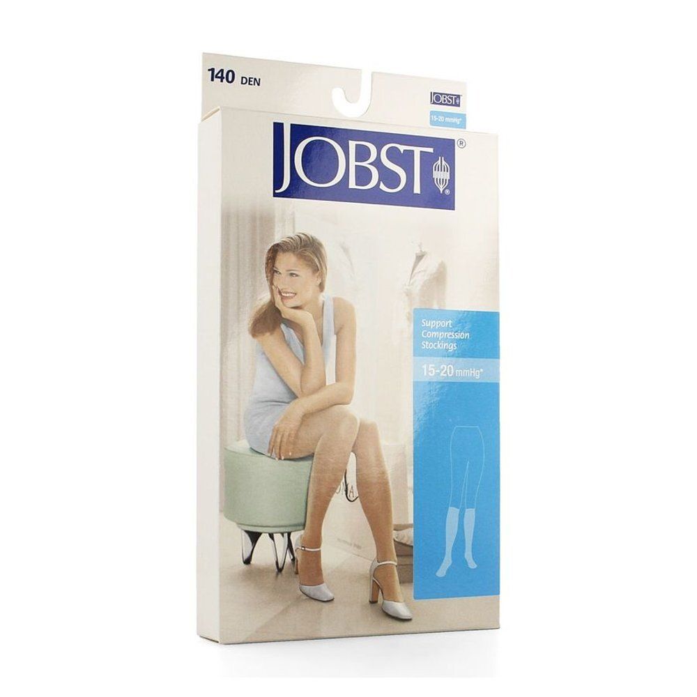 Boîte de bas de compression JOBST. Inscription: 140 DEN, 15-20 mmHg. Femme assise, portant des bas.
