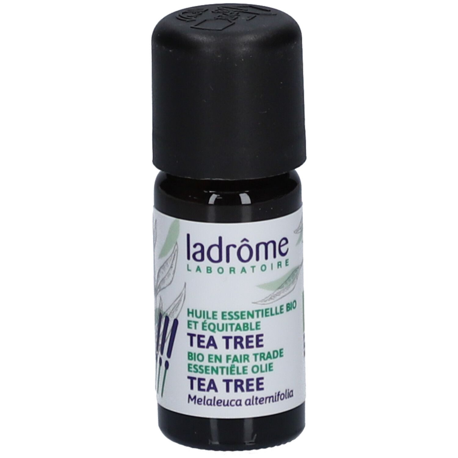 Flacon en verre brun avec bouchon noir. Étiquette avec nom du produit et logo. Inscription : Tea Tree.