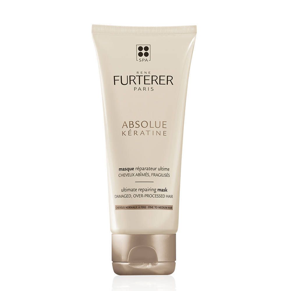 Creme-Tube mit Produktnamen und Logo. Text: Absolue Kératine, ultimative Reparaturmaske. Beige Tube mit braunem Verschluss.