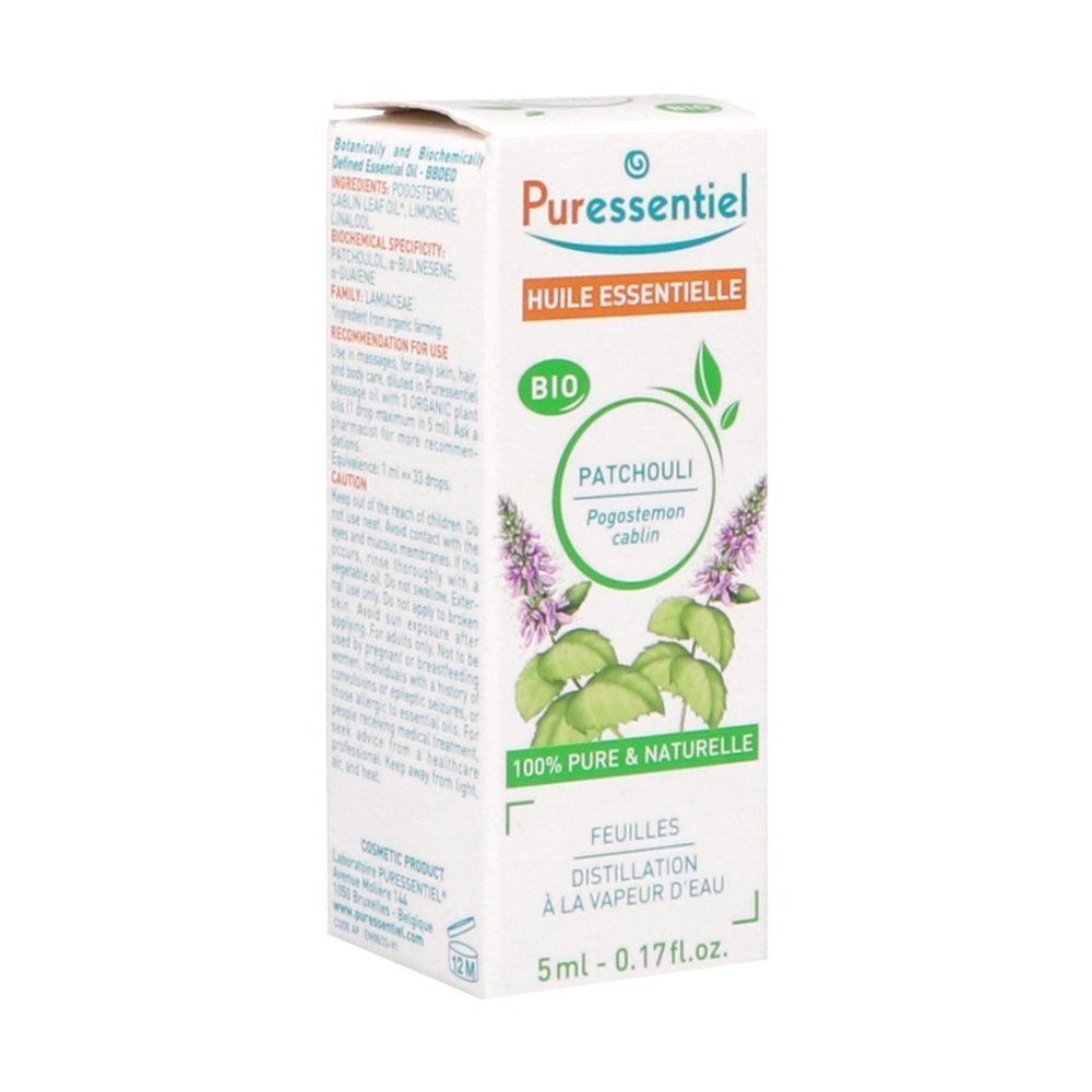Flacon d'huile essentielle Puressentiel Patchouli, face avant avec plante de patchouli.