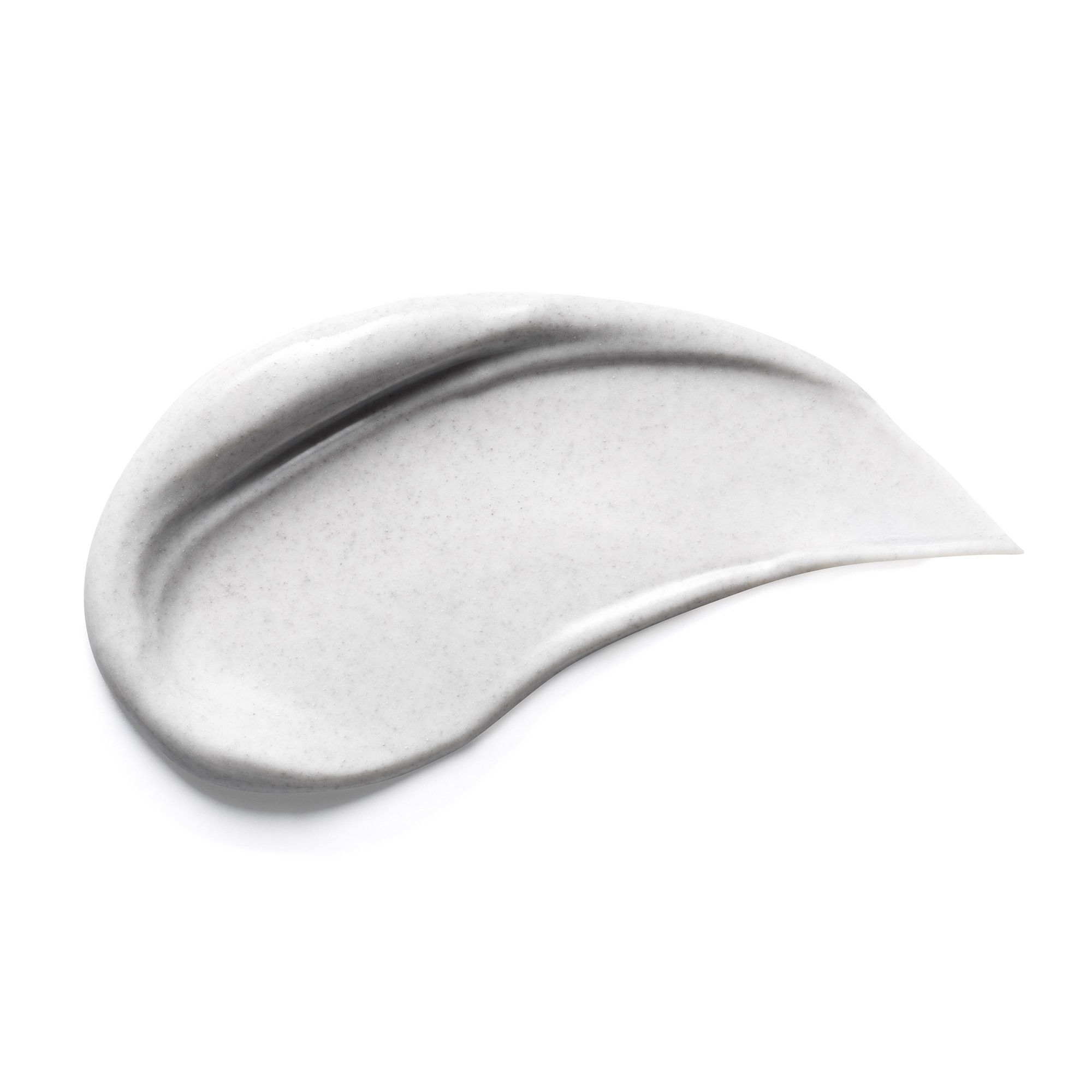 Ausgestrichene, cremefarbene Creme auf weißem Hintergrund. Textur und Form deutlich erkennbar.