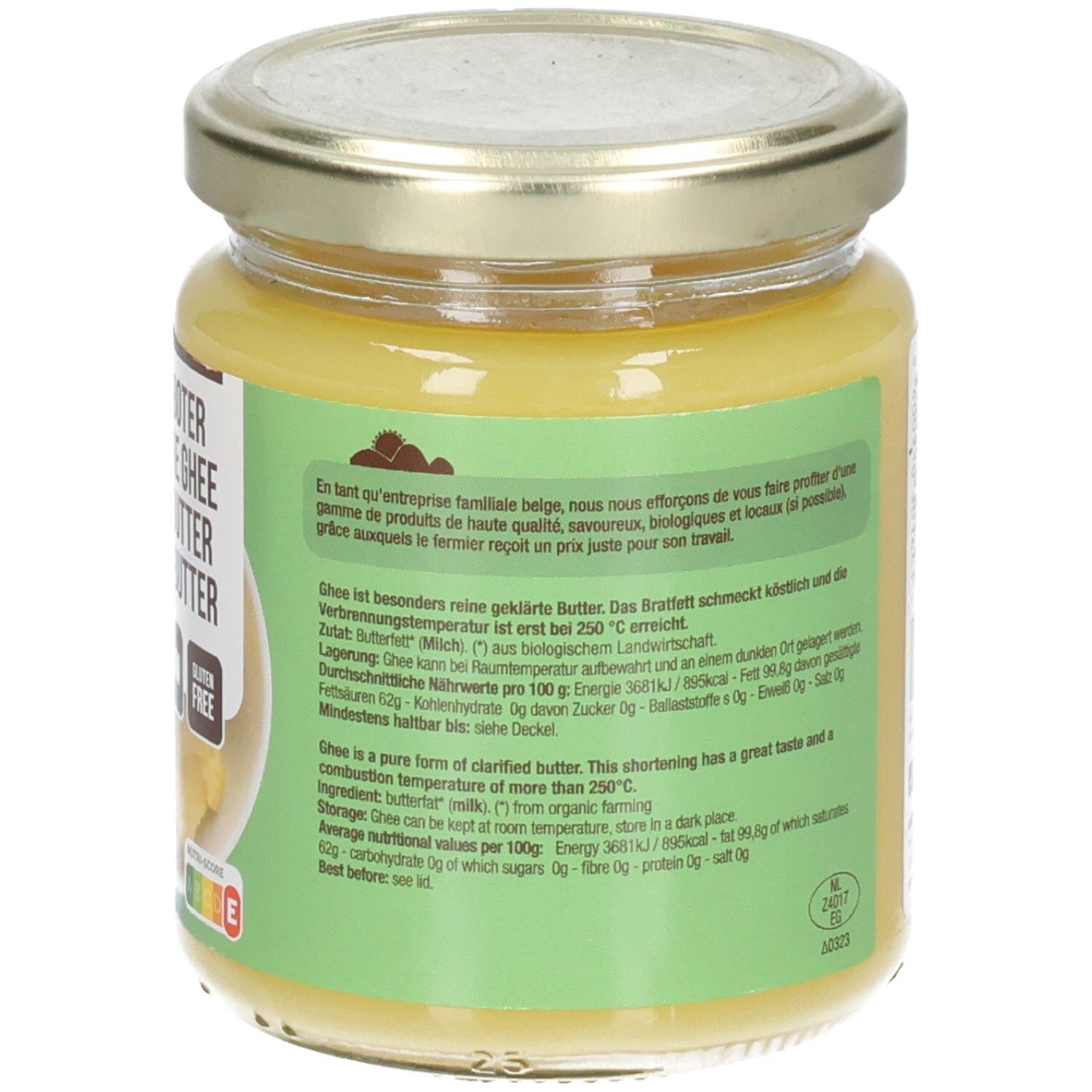 Rückseite eines Glases mit Ghee-Butter. Text auf grünem Etikett. Deckel mit Datumsangabe.
