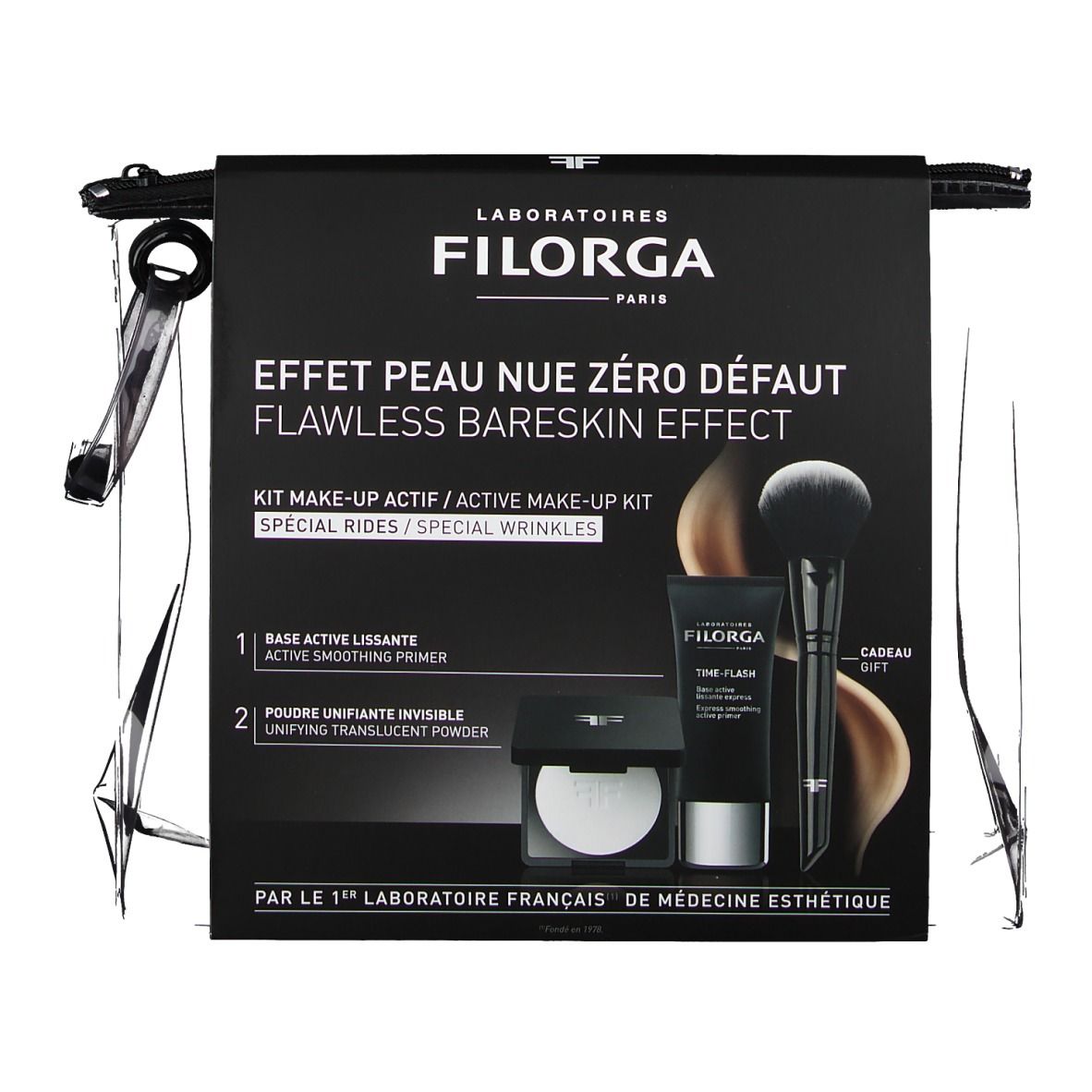 Verpackung mit Produkten. Schwarze Verpackung mit Text und Produkten. Enthält Pinsel, Tube und Puder. Marke: FILORGA.