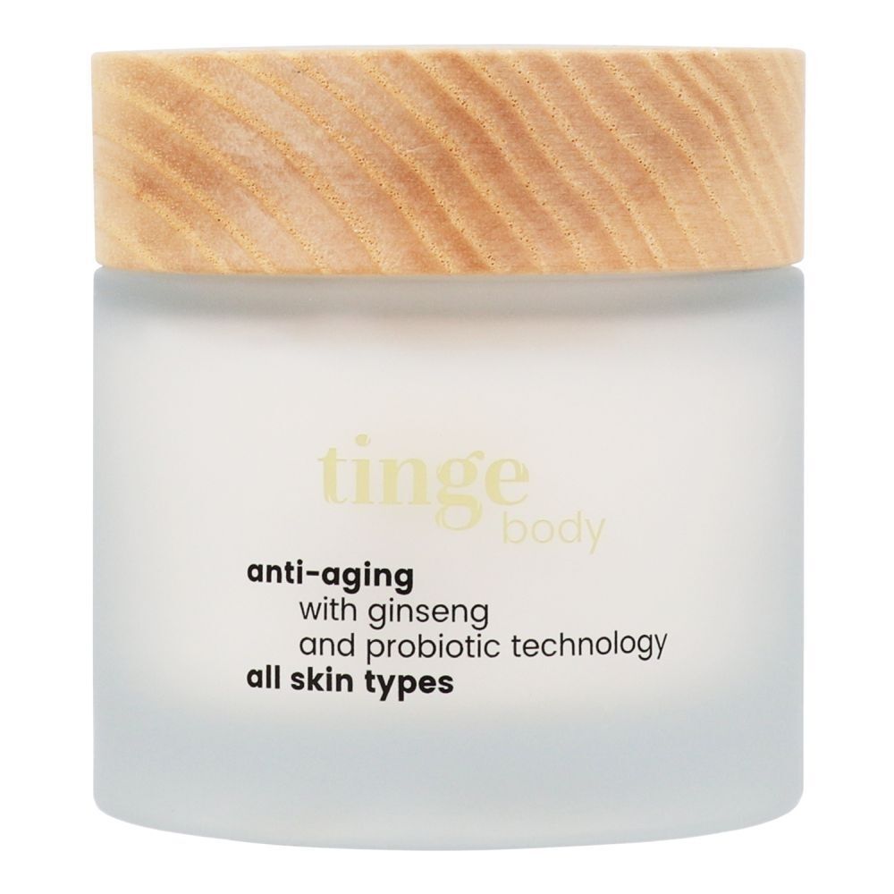 Tinge Bodylotion Anti-Aging dans un pot en verre dépoli avec un couvercle en bois.